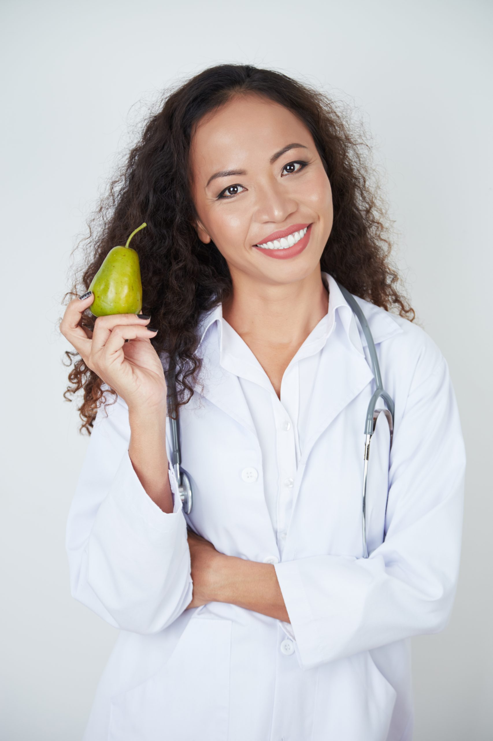 doctor holding ripe pear scaled